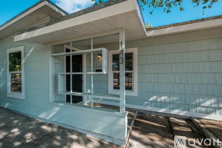 A house with a white porch and a window with the number 3 on it.