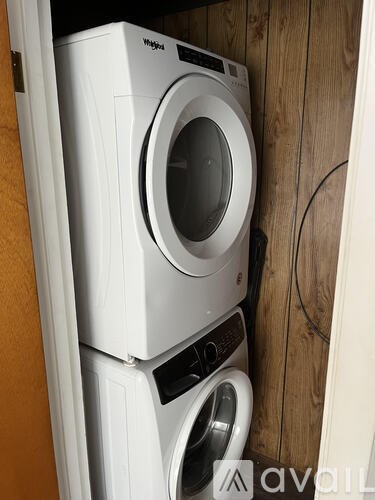 A stack of two white front loading washing machines.