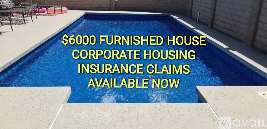A swimming pool in a backyard with a sign advertising $6000 furnished house corporate housing insurance claims available now.