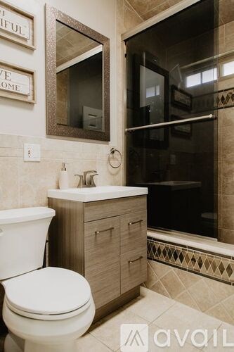 A white toilet sits next to a sink in a bathroom.
