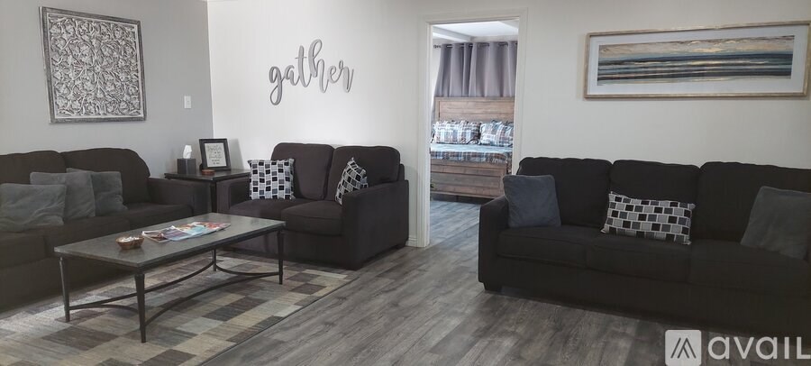 A living room with a sofa, a coffee table, and a couch.