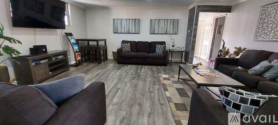 A living room with a grey sofa and a wooden coffee table.