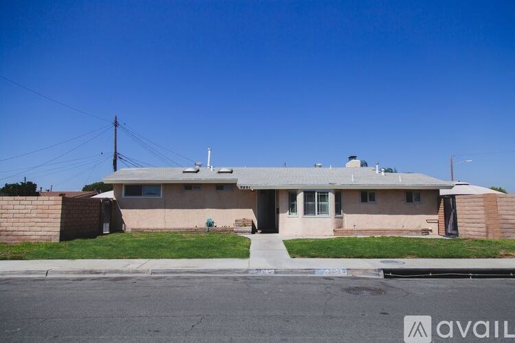A house with a beige exterior and a grey roof is available for rent.