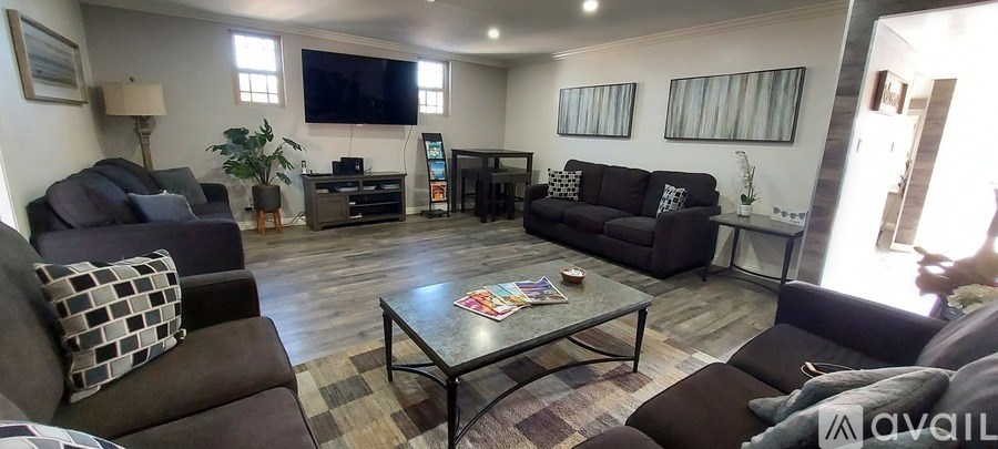 A living room with a couch, a coffee table, and a television.