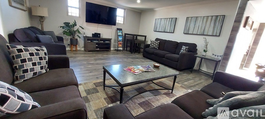 A living room with a large couch and a coffee table.