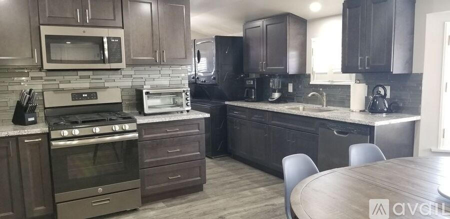 A kitchen with a stove, oven, and microwave.
