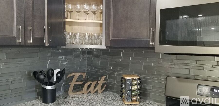 A kitchen counter with a knife block and a sign that says "Eat".