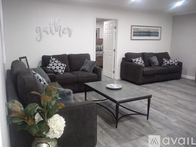 A living room with a grey couch and a coffee table.