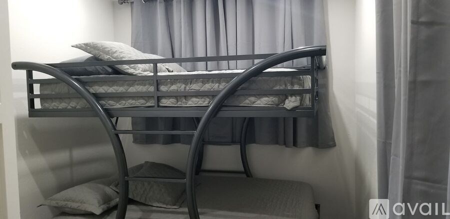 A bunk bed with a chair and pillows.