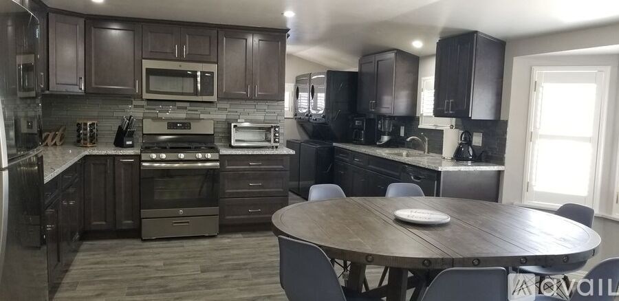 A kitchen with dark wood cabinets and a central island.