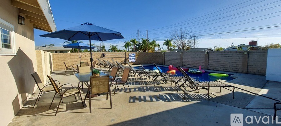 A patio with chairs and an umbrella is available for rent.