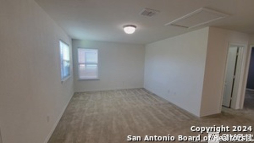 Empty room with a window and a door.