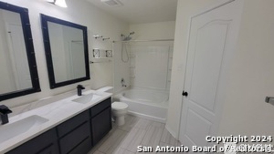 A bathroom with a toilet, sink, and mirror.