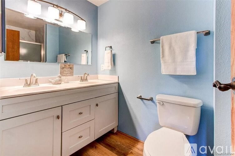 A white toilet sits next to a sink in a bathroom.