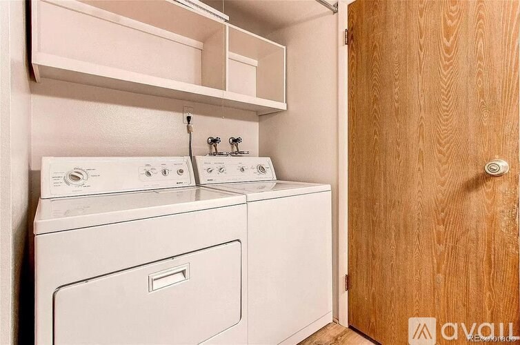 A small laundry room with a washer and dryer.
