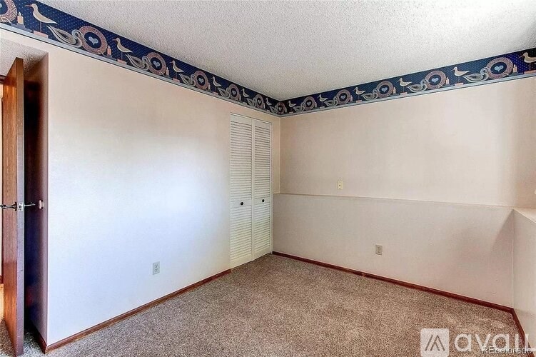 A room with a carpeted floor and a wall mural.