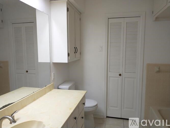A bathroom with a sink, toilet and medicine cabinet.