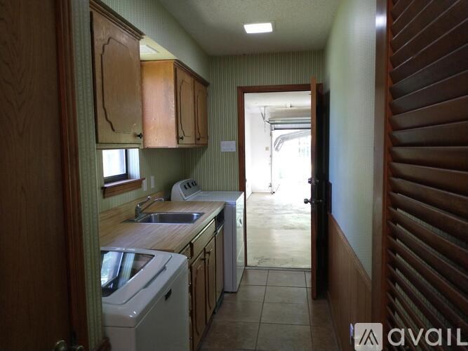 A small kitchen with a washing machine and a sink.