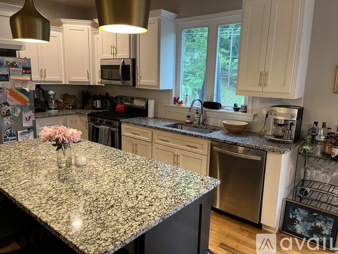 A kitchen with granite countertops and stainless steel appliances.