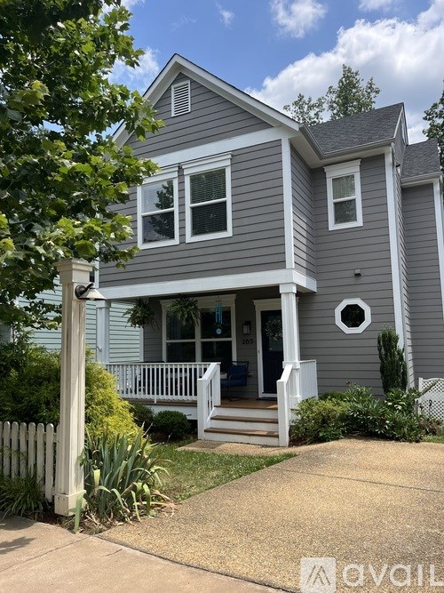 A house with a grey exterior and a white porch.