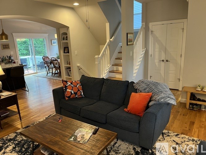 A living room with a grey couch and a coffee table.