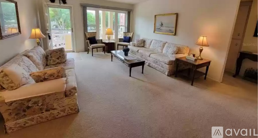A living room with a couch, chair, and coffee table.