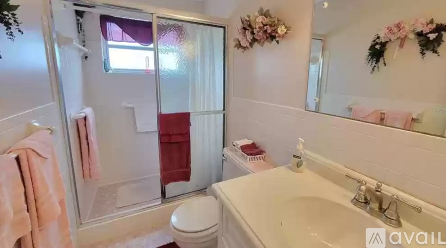 A bathroom with a toilet, sink, and shower.