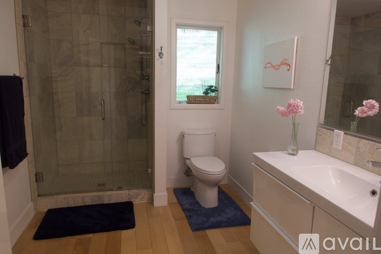 A bathroom with a toilet, sink, and shower.