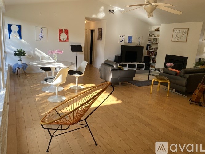 A living room with a fireplace and a TV.
