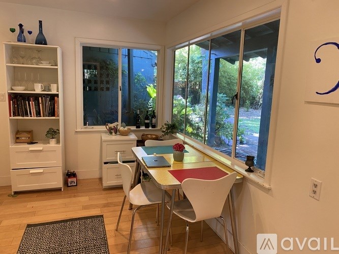 A dining area with a table and chairs is shown in the image.