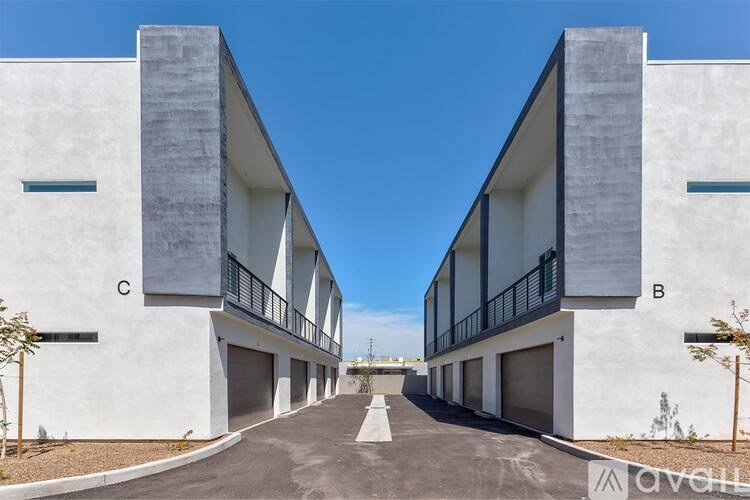 A modern building with a clear blue sky above it.