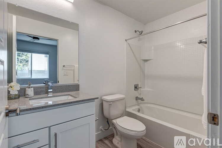 A bathroom with a toilet, sink, and bathtub.