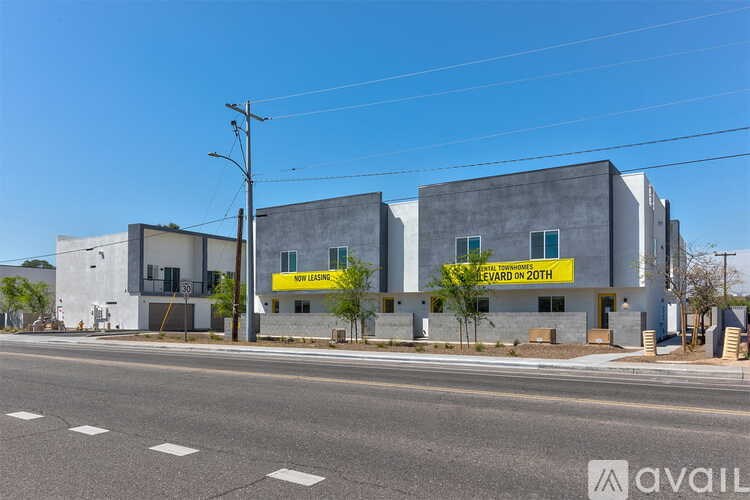 A modern building with a yellow sign that says "LEVARD 20TH".