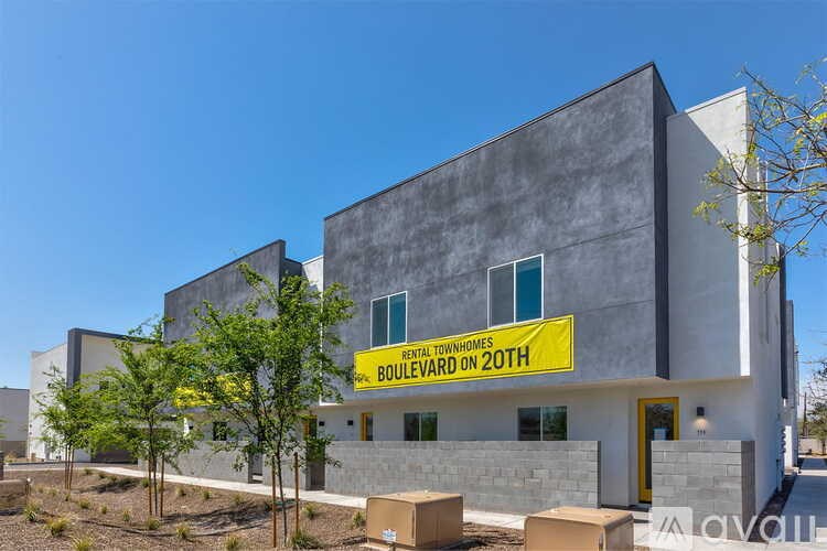 A modern building with a yellow sign that says "RETAIL TOWNSHIP BOULEVARD ON 20TH".