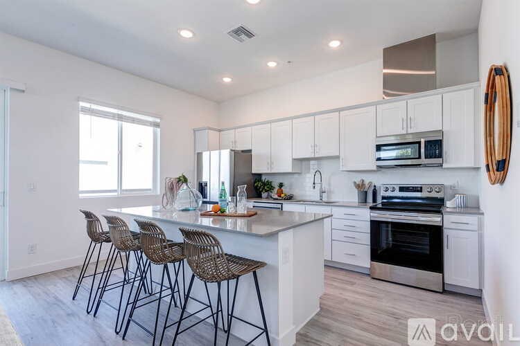 A modern kitchen with white cabinets and a center island.
