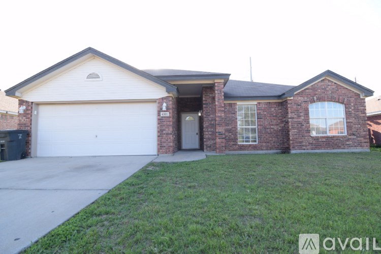 A house with a garage and a brick wall.