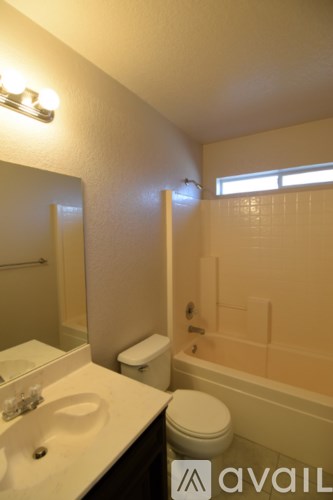 A bathroom with a toilet, sink, and bathtub.