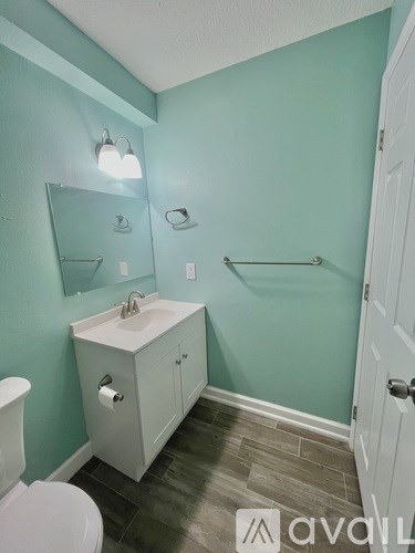 A bathroom with a white toilet and sink.