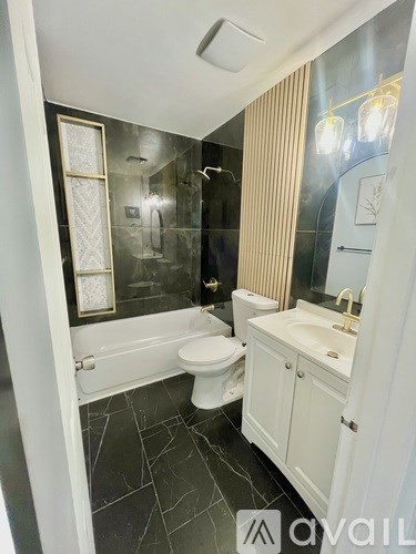 A bathroom with a toilet, sink, and mirror.