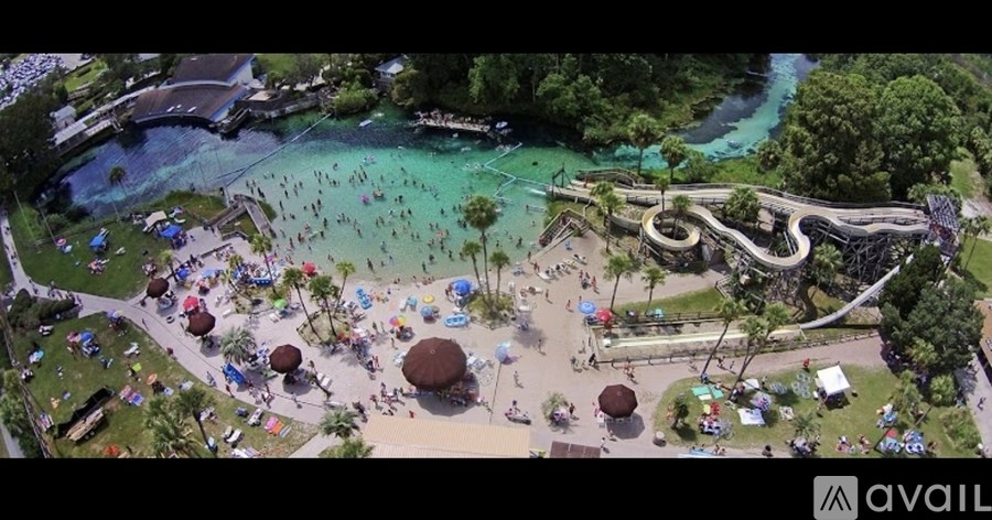 A busy water park with people enjoying the facilities.