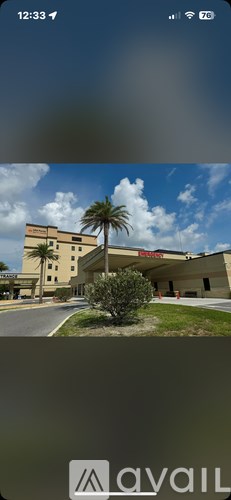 A building with a palm tree in front of it.