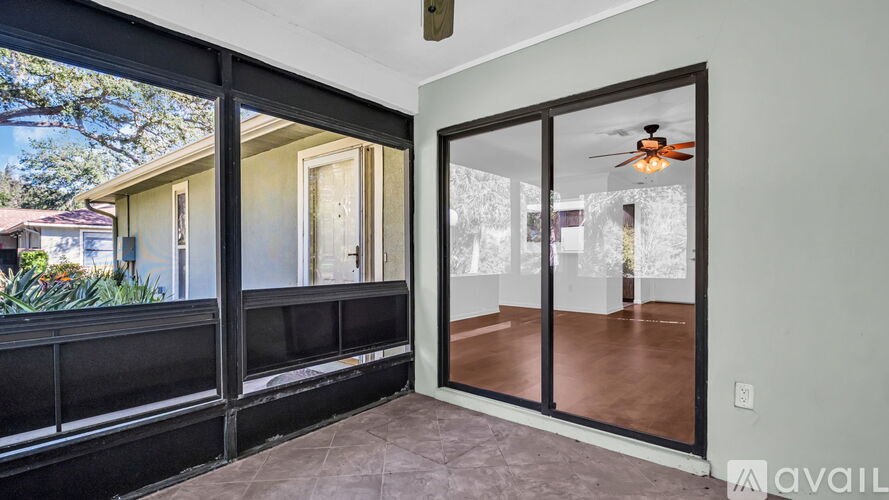 A balcony with a railing and a ceiling fan.