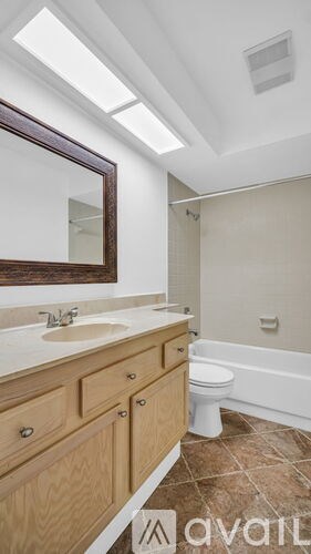 A bathroom with a toilet, sink, and tub.
