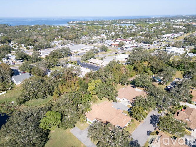 An aerial view of a residential area with houses and trees.