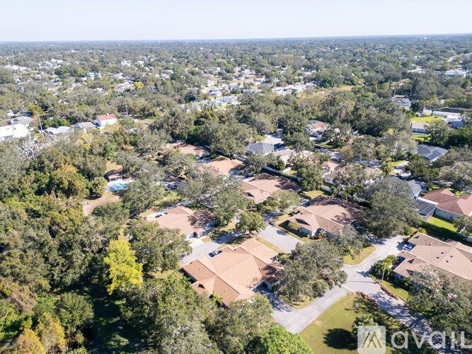 A bird's eye view of a residential area with houses and trees.