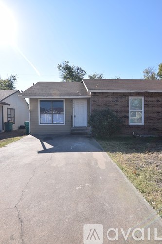 A kitchen with wooden floors and white appliances.