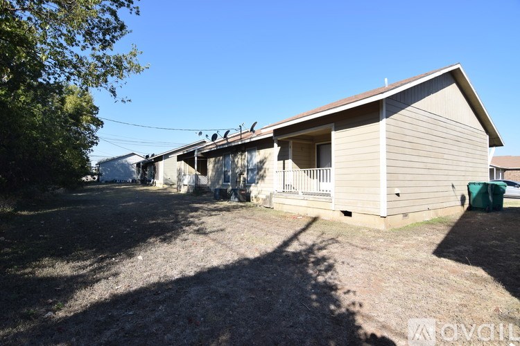A house with a garage and a driveway in front of it.