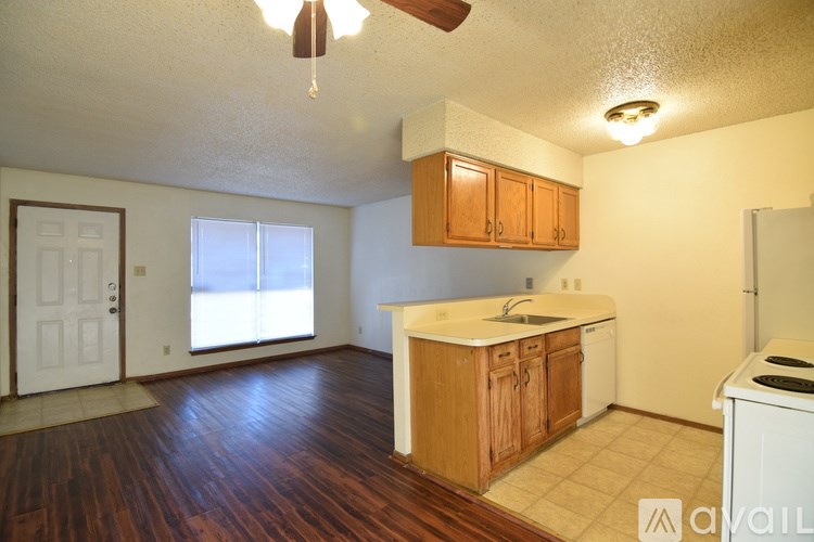 A room with a carpeted floor, a door, and a window.