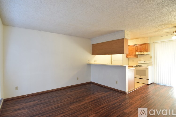 A room with a carpeted floor and two doors.
