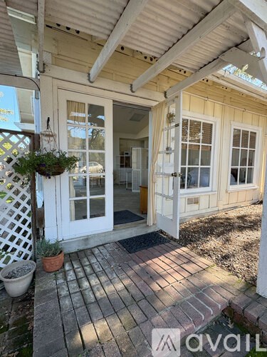 A patio area with a door and a planter.